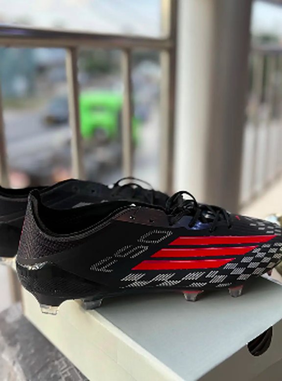Black and red striped football boots