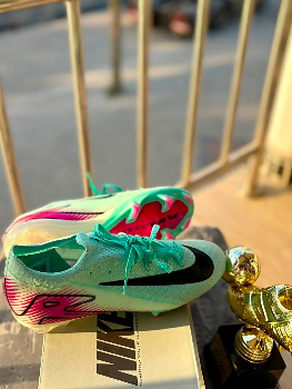 Mint and pink football boots