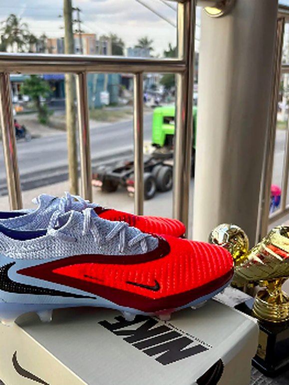 Silver and red football boots