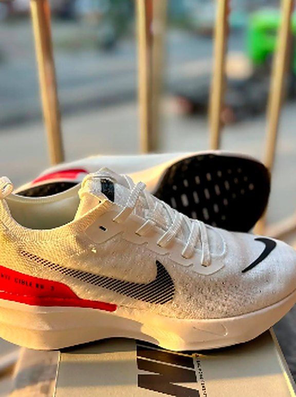 White running shoes with red sole